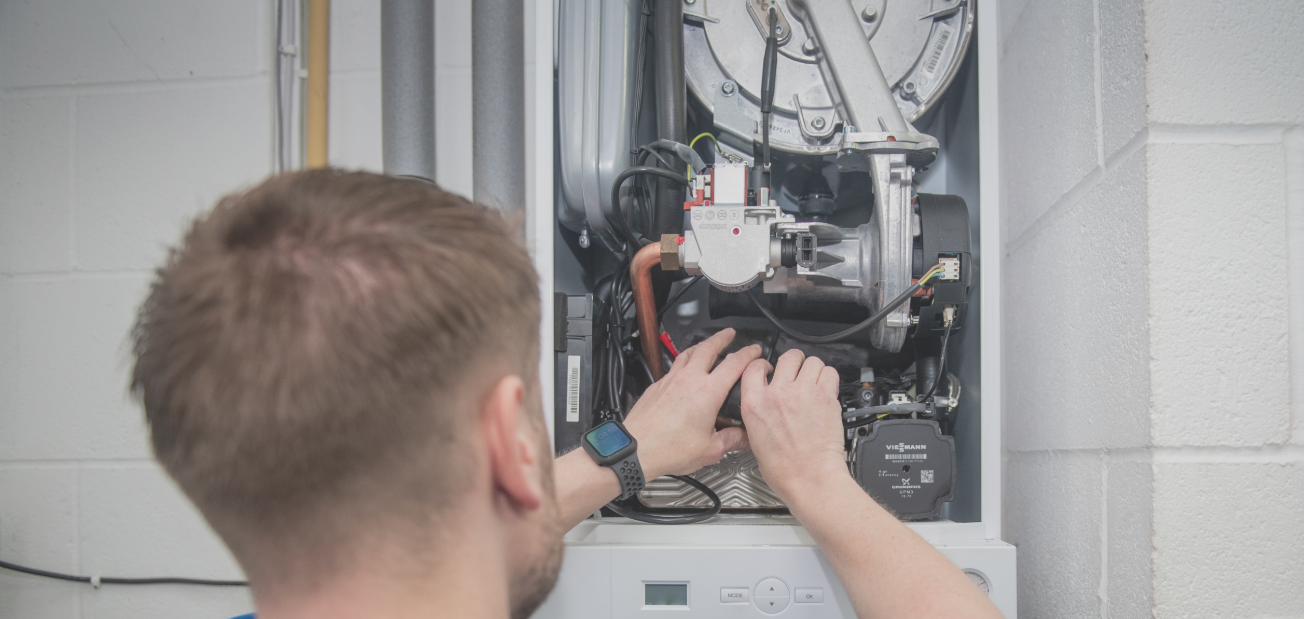Ecotech engineer carrying out planned maintenance in a South Yorkshire community centre