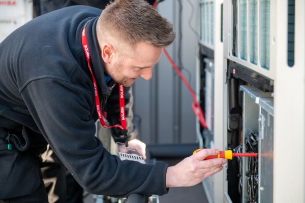 Ecotech engineer installing air conditioning in a South Yorkshire retail unit before opening hours