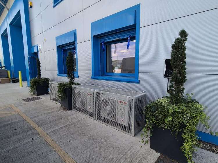 Air conditioning condenser units integrated along the building's exterior service line