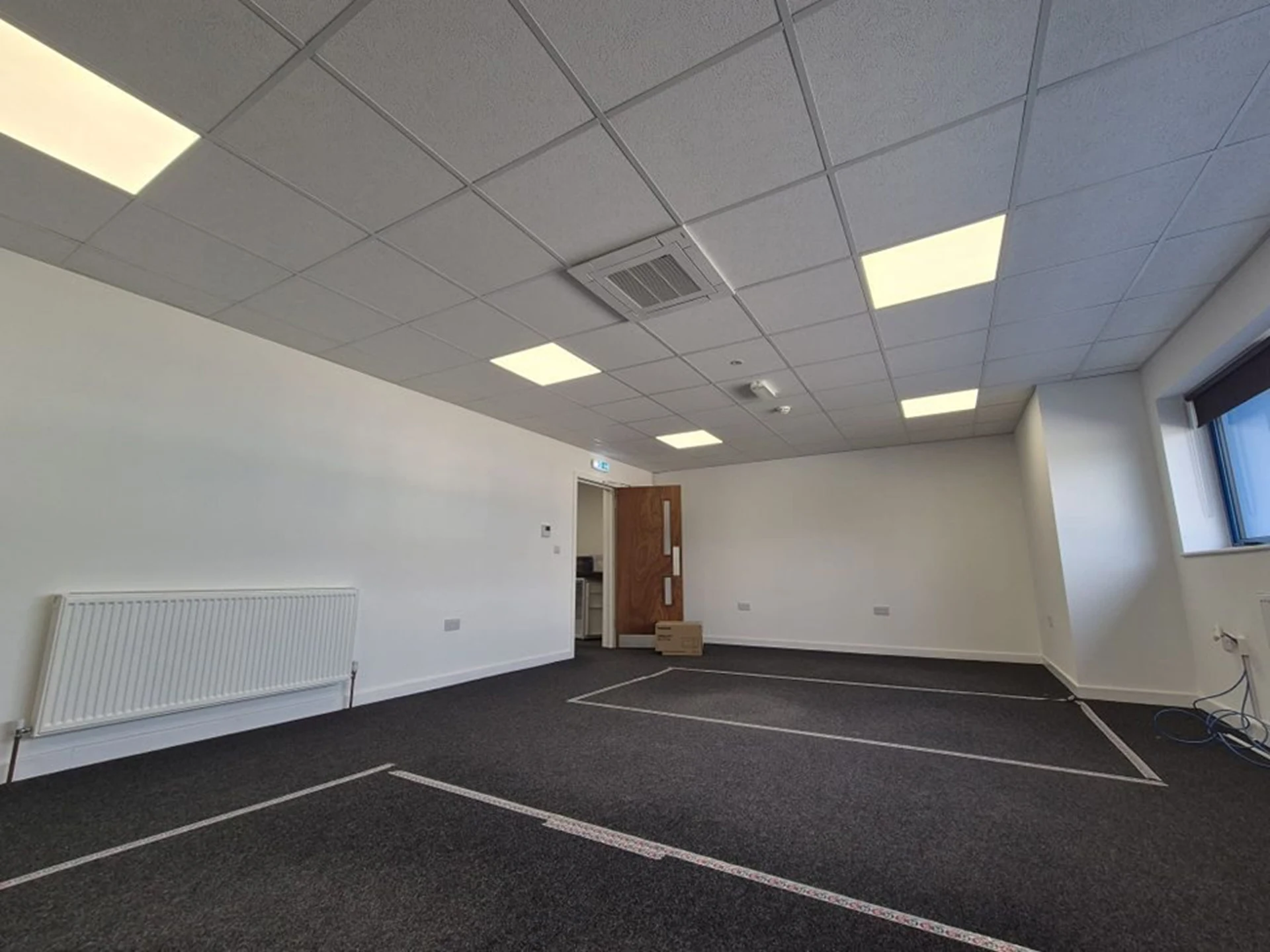 Completed office fit-out with ceiling cassette air conditioning unit installed in commercial suspended ceiling