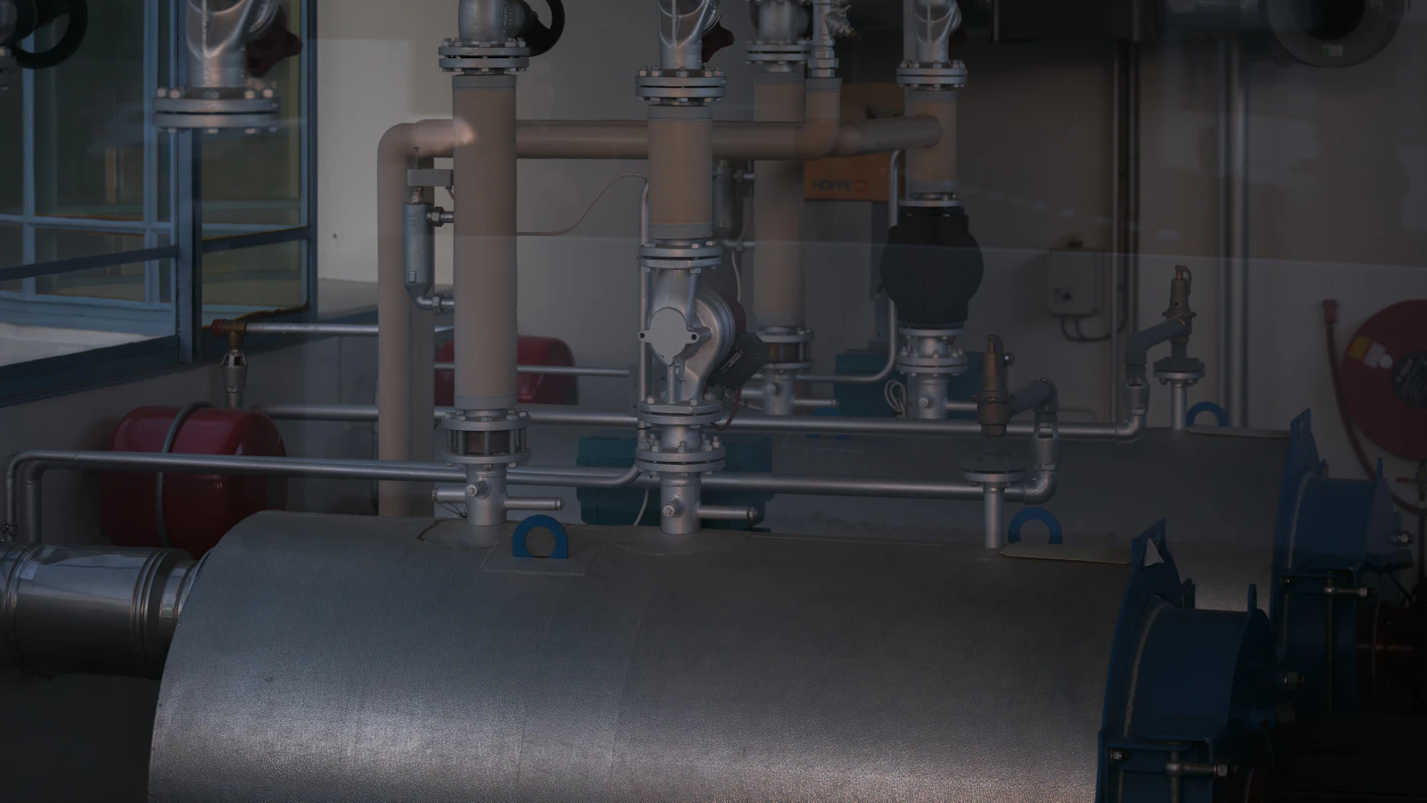 Commercial plant room with heating pipework, valves and expansion vessels